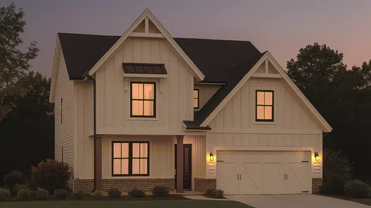 Modern two-story farmhouse with illuminated windows, white siding, and a double garage at dusk.