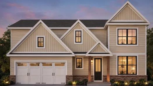 Modern two-story beige house with large windows and a double garage at sunset with warm interior lights.